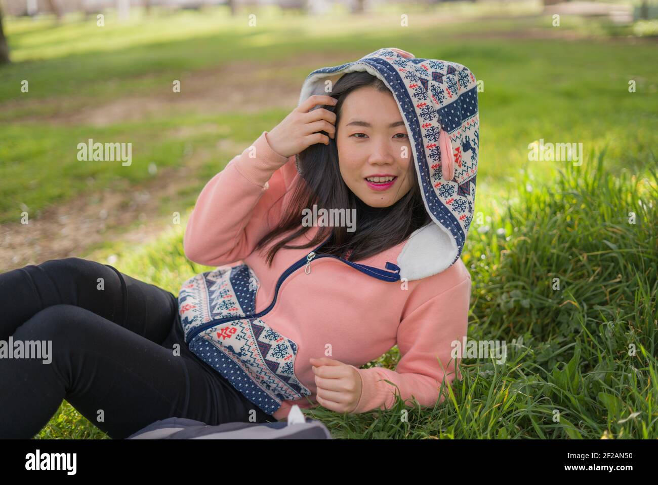 Sweet Asian Woman In Hoodie Making Faces Lifestyle Portrait Of Young Happy And Beautiful Chinese Girl Sitting Playful On Green Grass In City Park Sm Stock Photo Alamy Sweet Asian Woman In Hoodie Making Faces Lifestyle Portrait Of Young Happy And Beautiful Chinese Girl Sitting Playful On Green Grass In City Park Sm Stock Photo Alamy