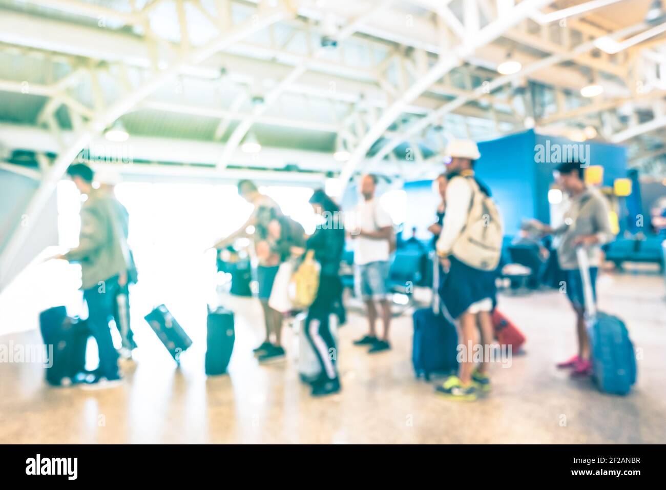 Blurred defocused people waiting in queue at terminal gate of international airport for airplane trip - Travel wanderlust concept Stock Photo