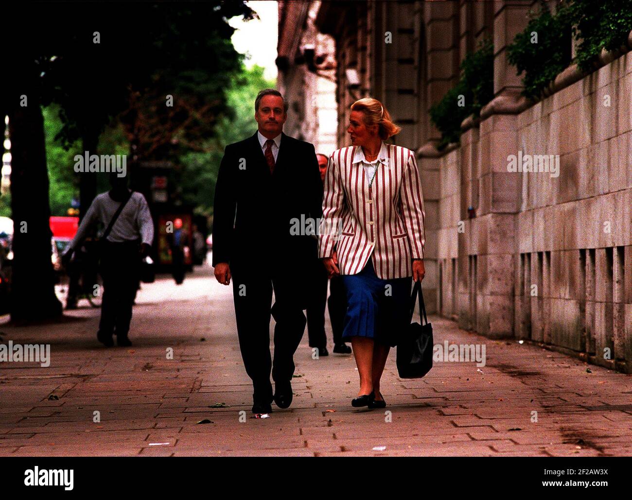 Neil Hamilton former MP for Tatton with his wife Christine near the Millbank media centre Westminster after hearing the findings of the Downey report into the cash for questions scandal Stock Photo