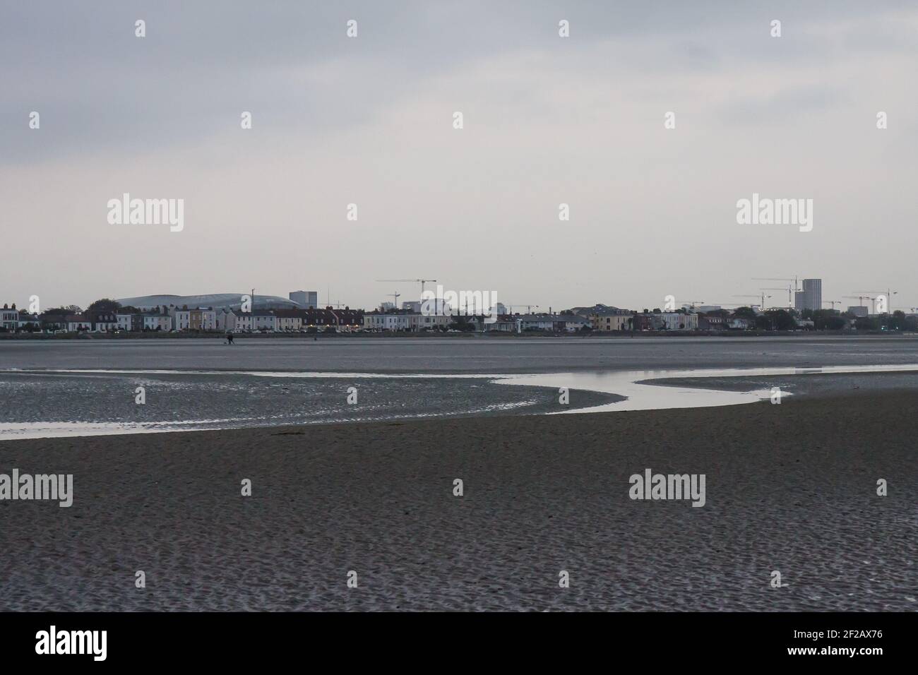 Beach texture, low tide beach, sand structure and city view, beach at low tide, water, sea water, creak, sand texture, corrugated beach, Stock Photo