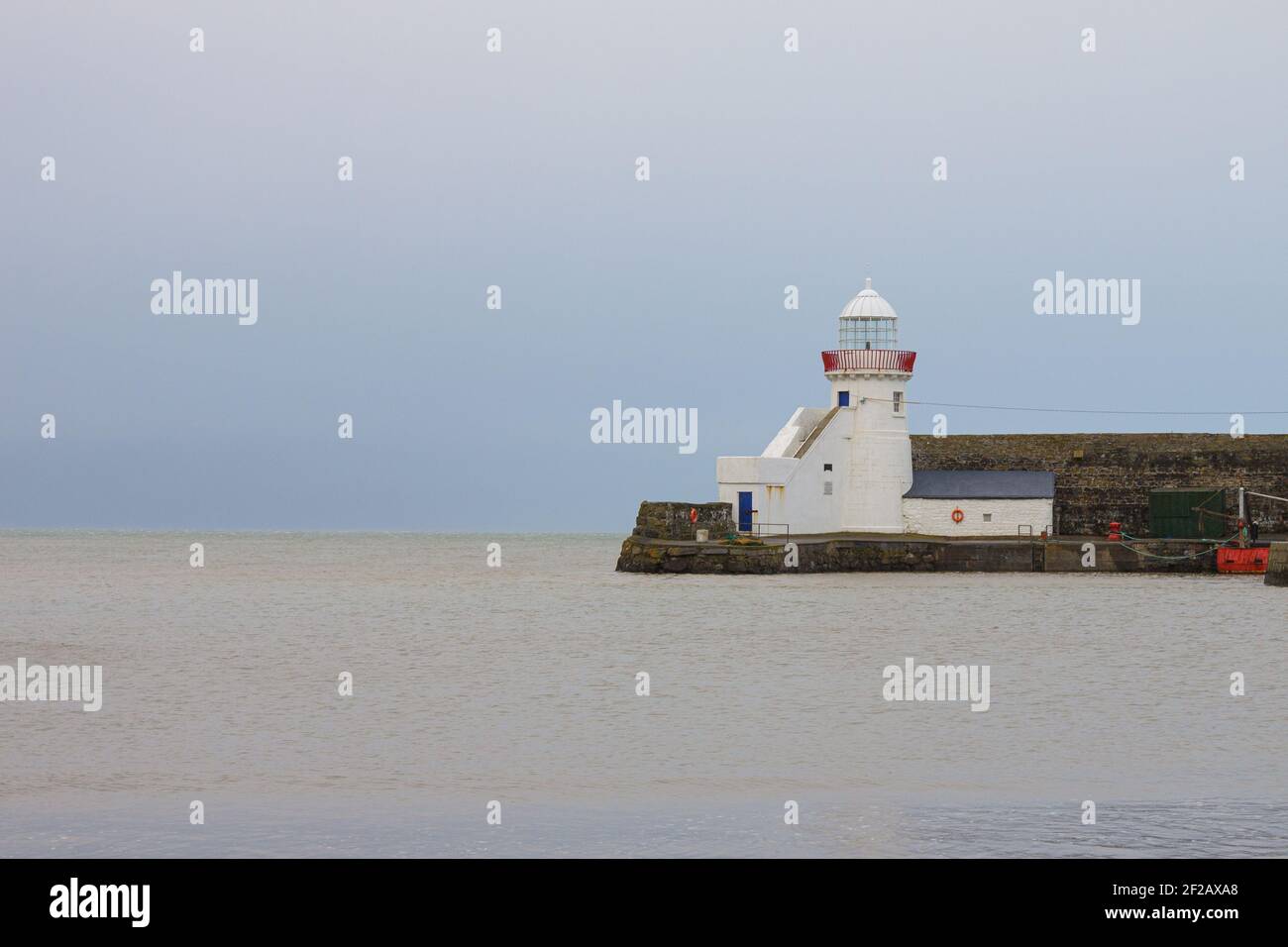 Lighthouse in Balbriggan, Ireland calm before storm Dennis, calm water, long exposure blue hour shot after sunset Stock Photo