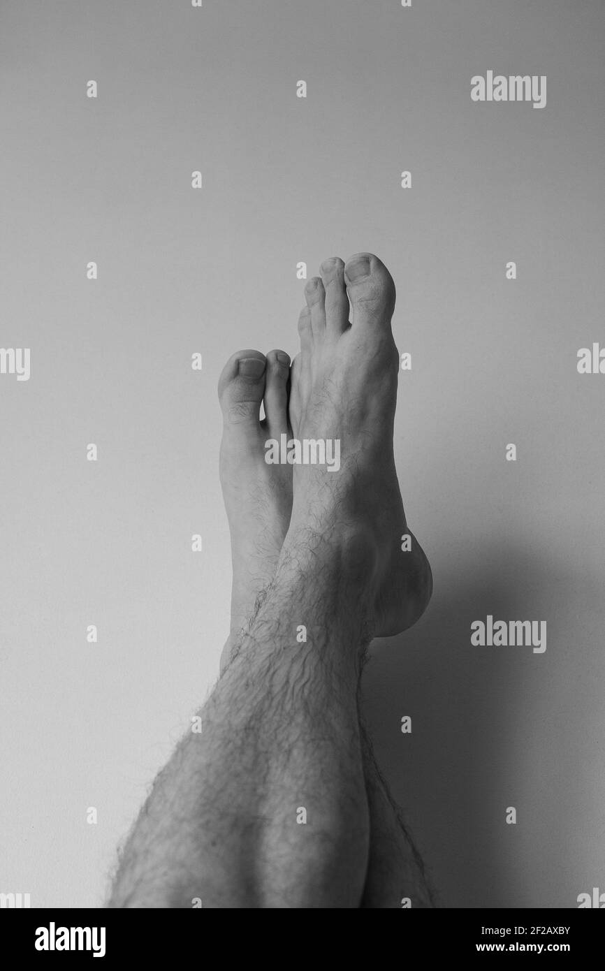 Bare feet against the wall, black and white photo, be creative during