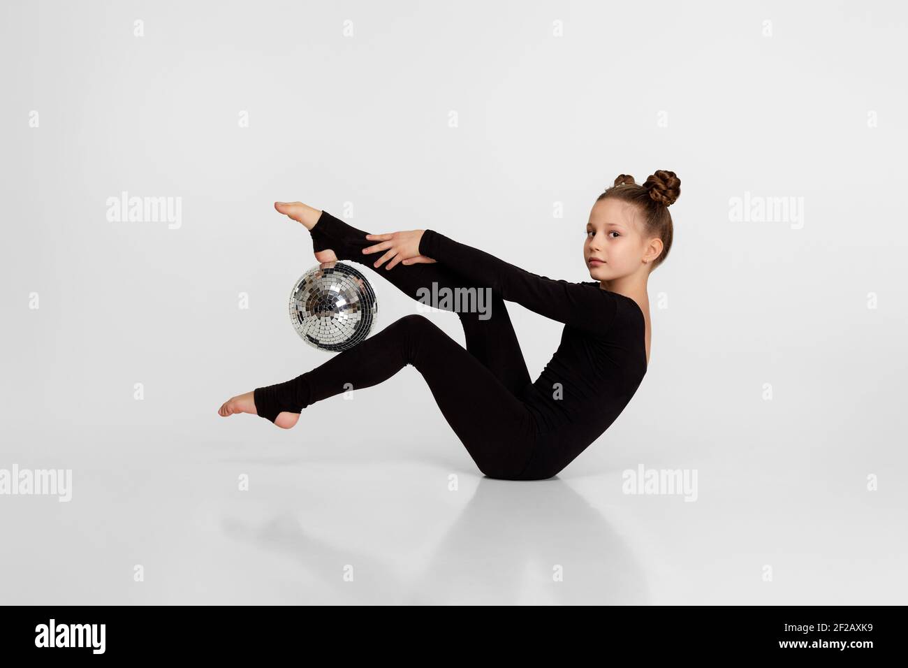 Little girl doing gymnastics on color background :: Stock Photography  Agency :: Pixel-Shot Studio