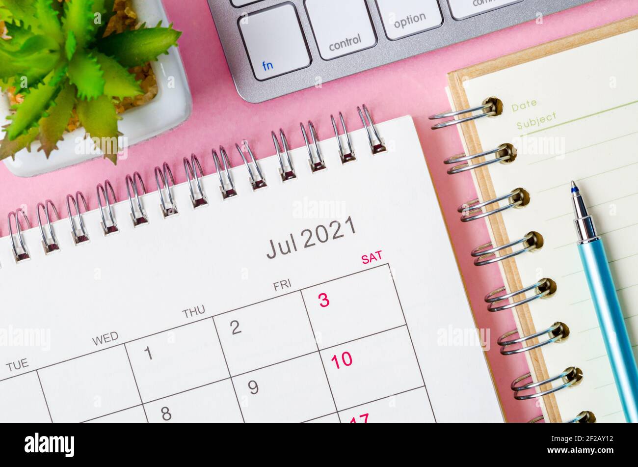 July 2021 calendar with note book on pink background Stock Photo - Alamy