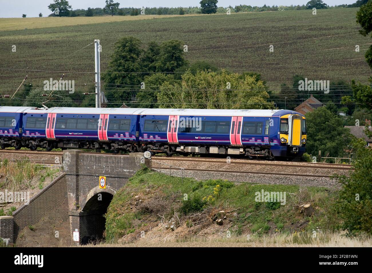 Class 377 passenger train in First Capital Connect livery speeding through the English countryside. Stock Photo