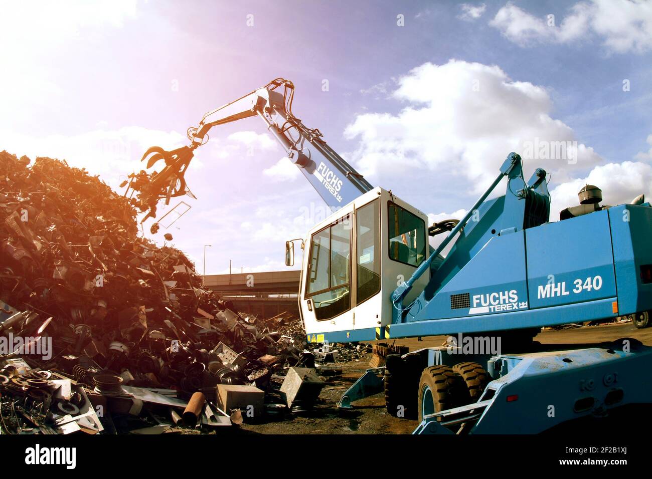 Fuchs MHL 340 mobile grab machine working at a waste site in the UK. Stock Photo