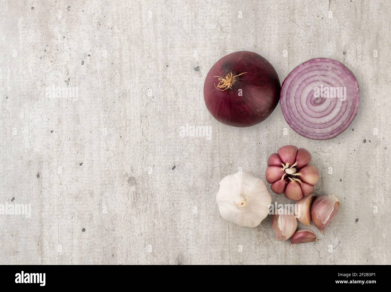 Onion, garlic bulb and cloves with copy space Stock Photo - Alamy