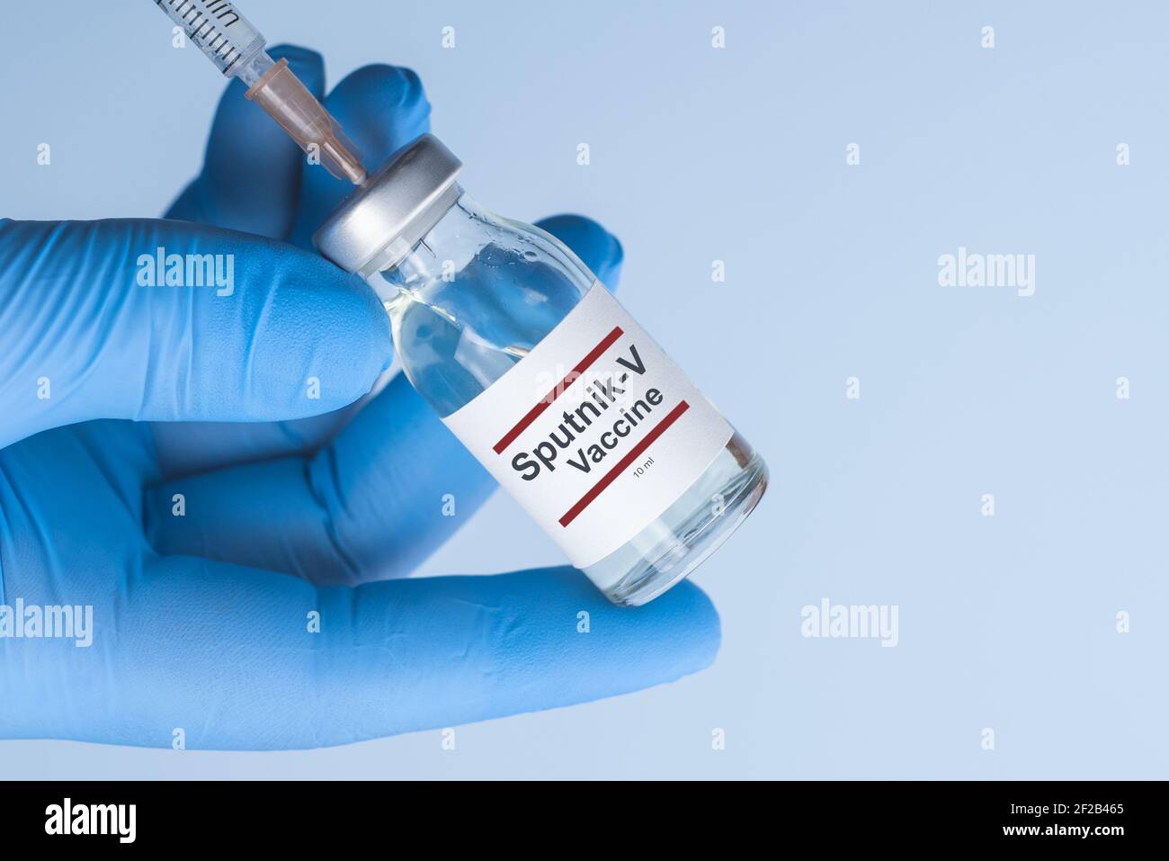 Coronavirus vaccine concept and background. New vaccine sputnik-v isolated on blue background. Covid-19, 2019-nCov pandemic. Stock Photo