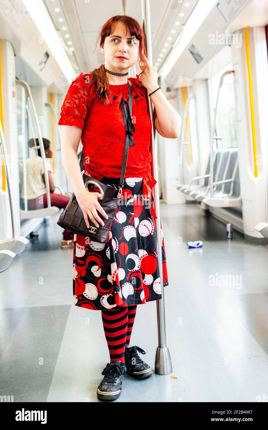 Amsterdam, Netherlands. Young, redhaired woman riding an elevated subway train homebound through Sout-East Bijlmermeer. Stock Photo