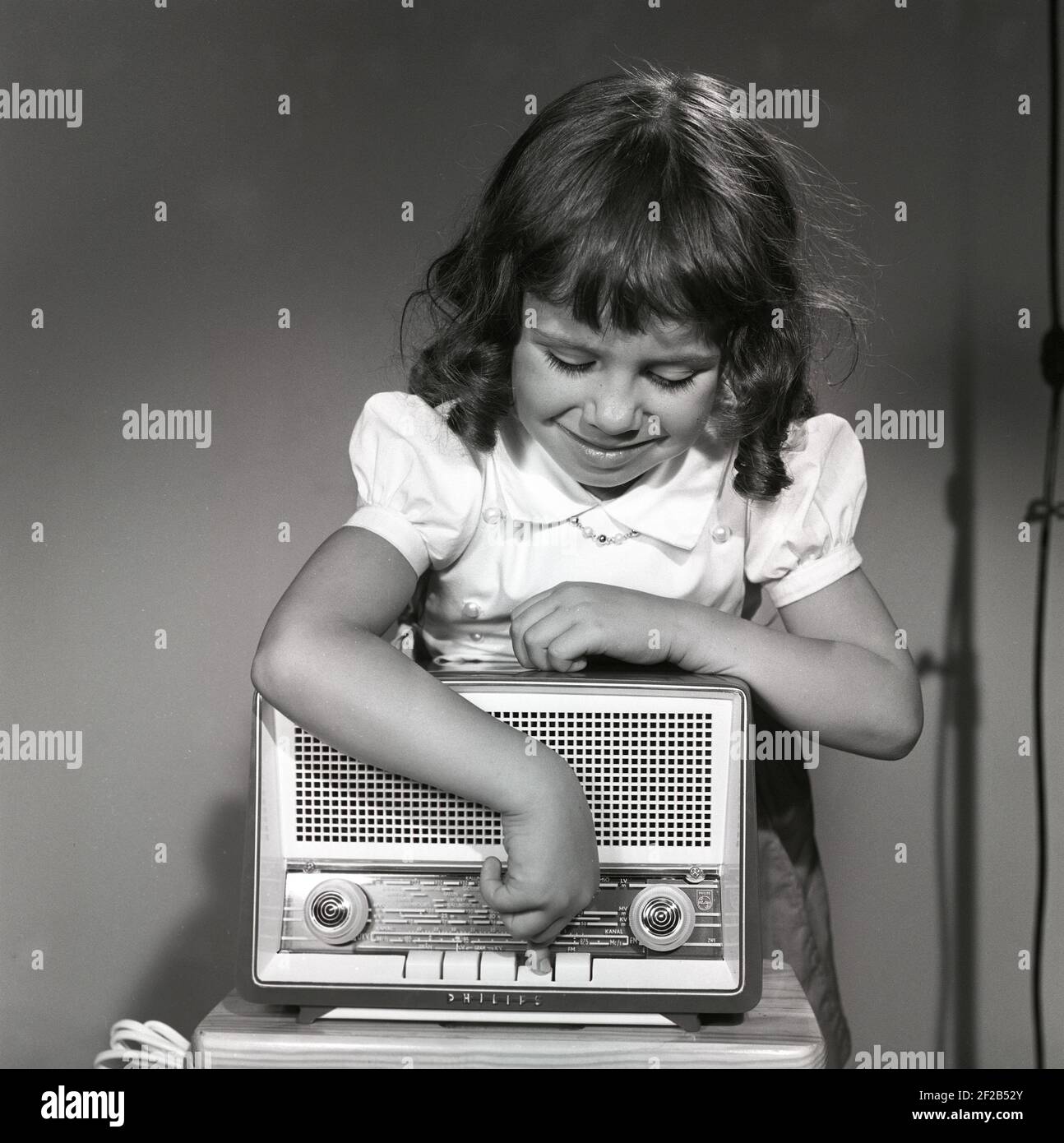 In the 1950s. A girl with a Philips radio set. On the front of it a scale  with information of different radiostations and frequencies. Sweden 1959.  ref CG70-9 Stock Photo - Alamy