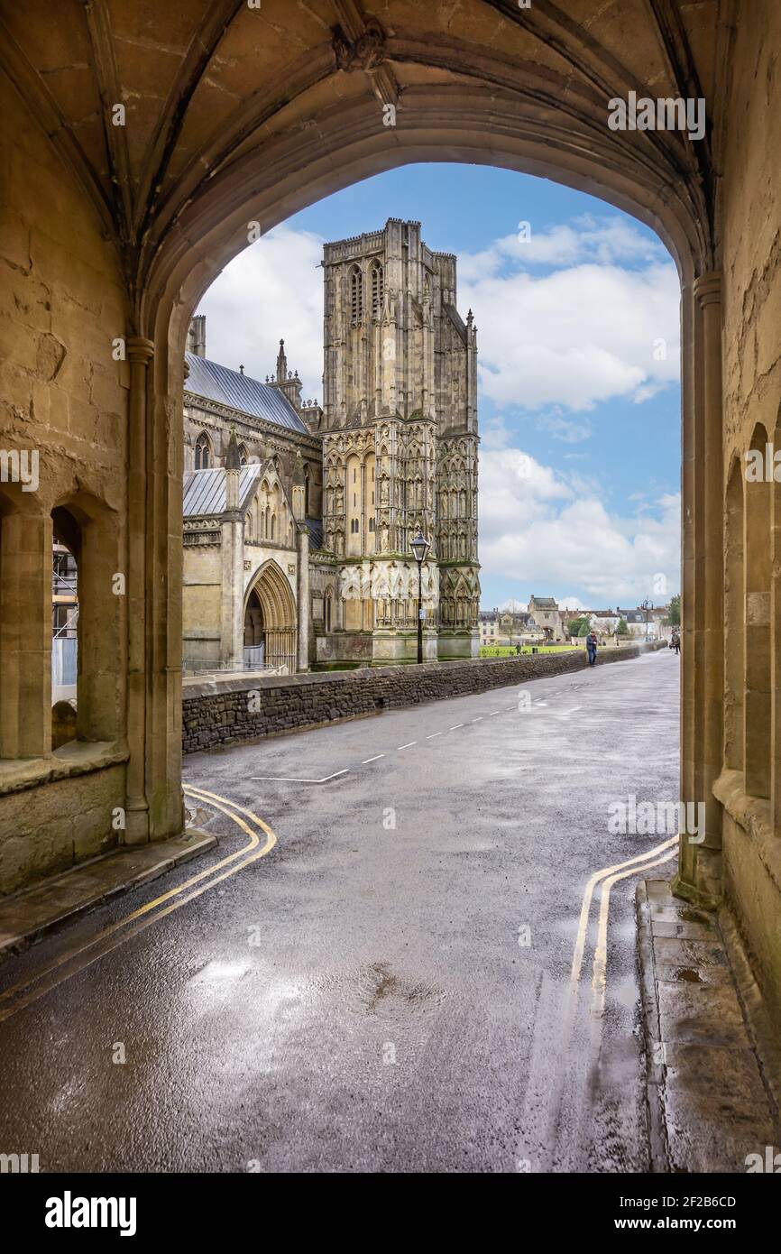 View of Wells cathedral looking through the medieval arch over St Andrews Street in Wells, Somerset, UK on 11 March 2021 Stock Photo