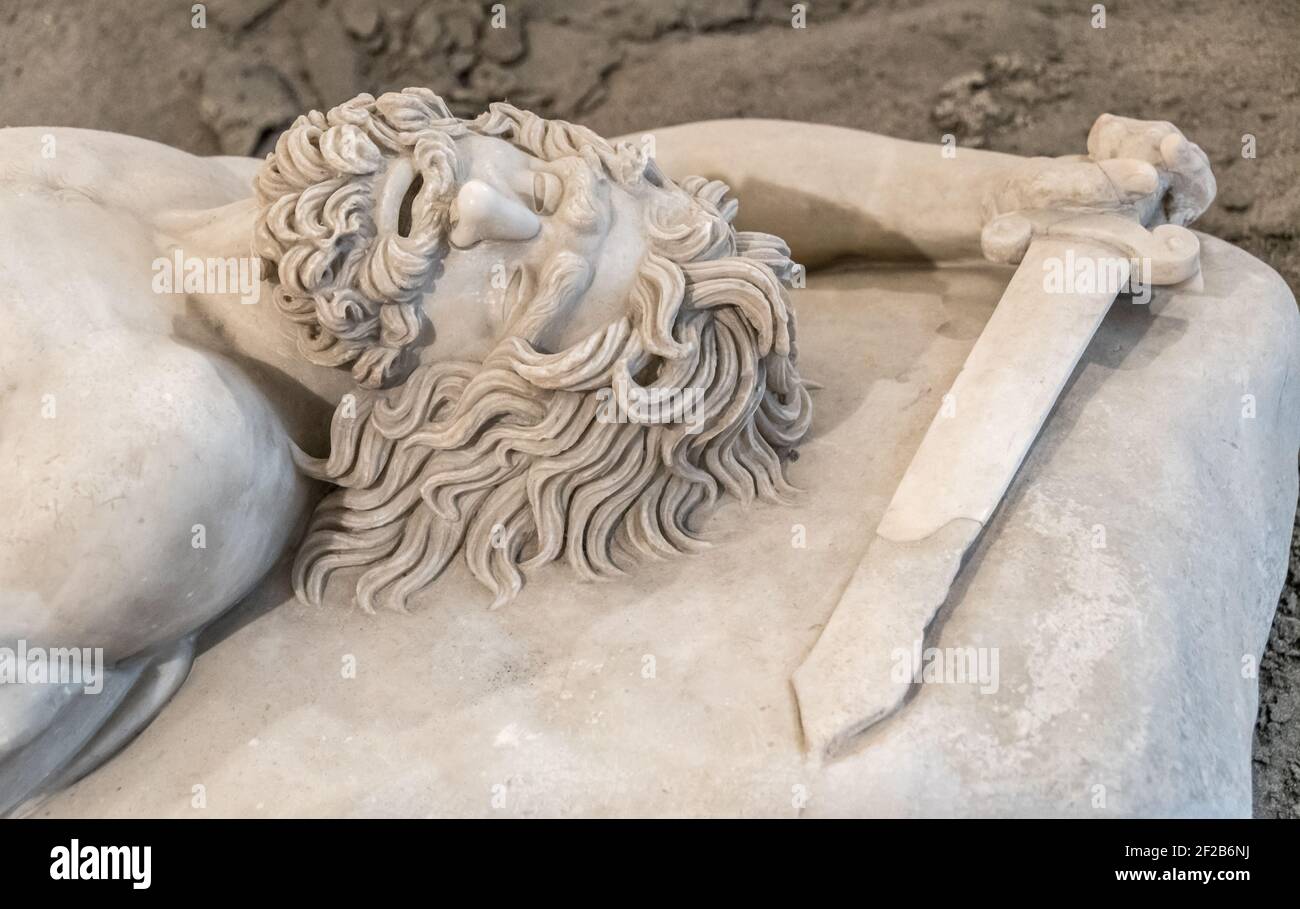 Dead warrior - Small Pergamene Votive Offering. Roman marble statue, copy of original greek statue in MANN (Museo archeologico Nazionale di Napoli) Stock Photo