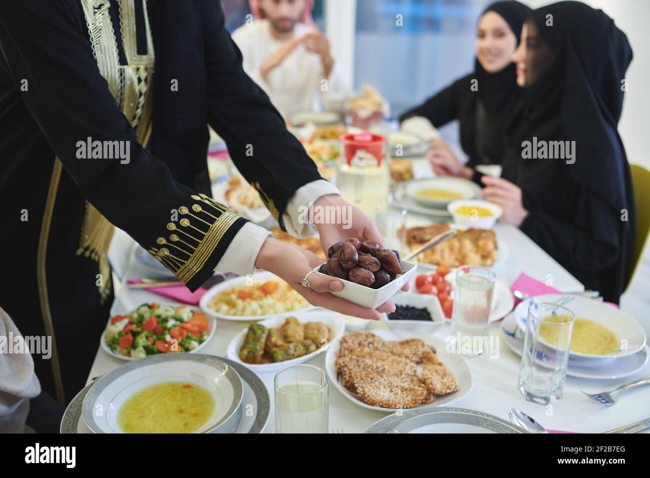 Muslim family starting iftar with dates during Ramadan Stock Photo Alamy