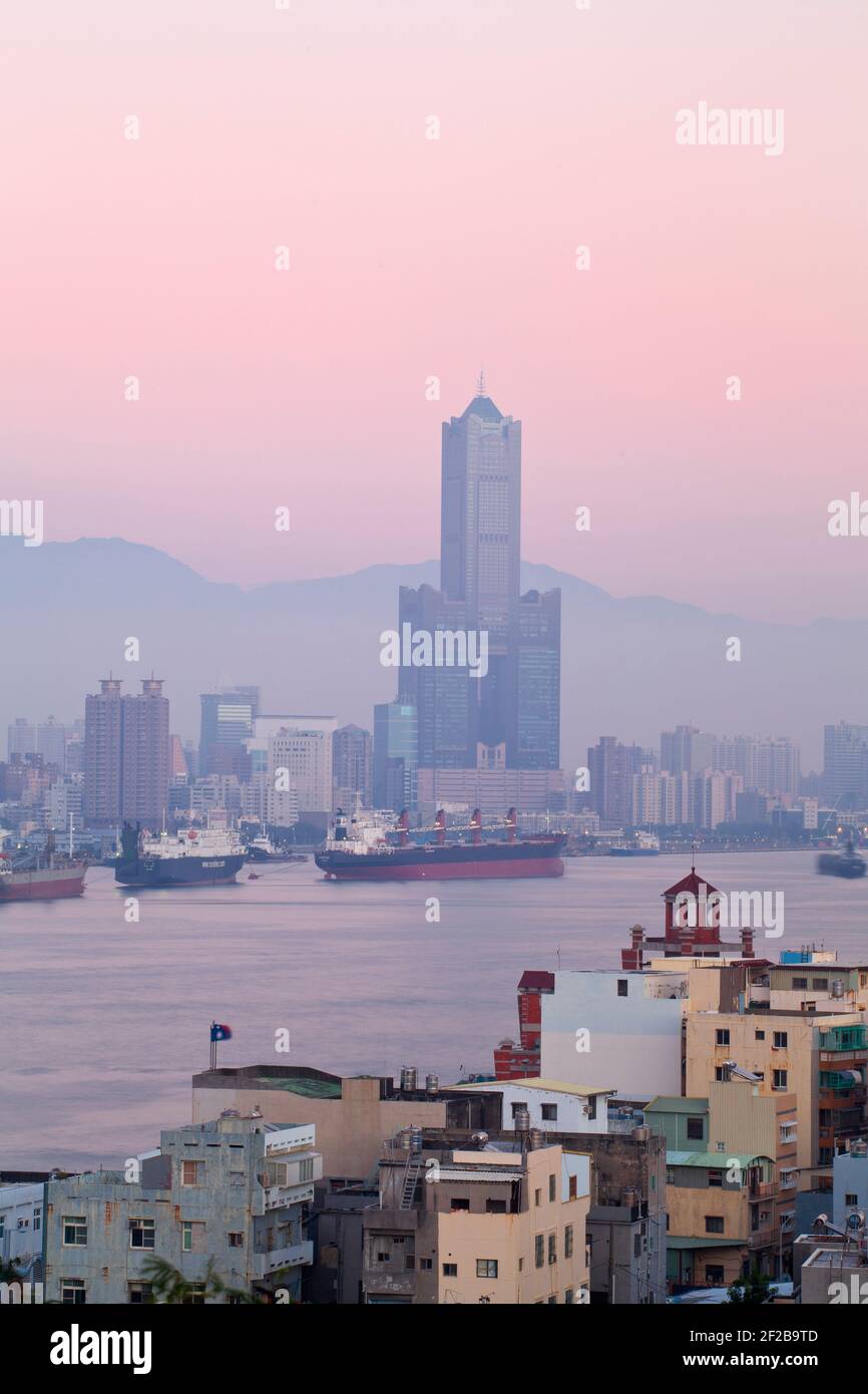 Taiwan, Kaohsiung, View of Cijin and harbour looking towards the city and  Kaoshiung 85 Sky Tower - Tunex Sky Tower Stock Photo