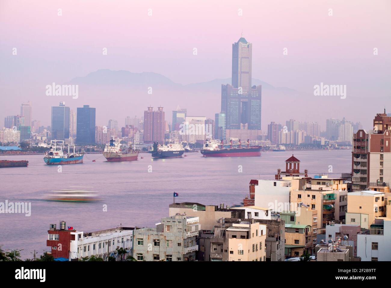 Taiwan, Kaohsiung, View of Cijin and harbour looking towards the city and  Kaoshiung 85 Sky Tower - Tunex Sky Tower Stock Photo