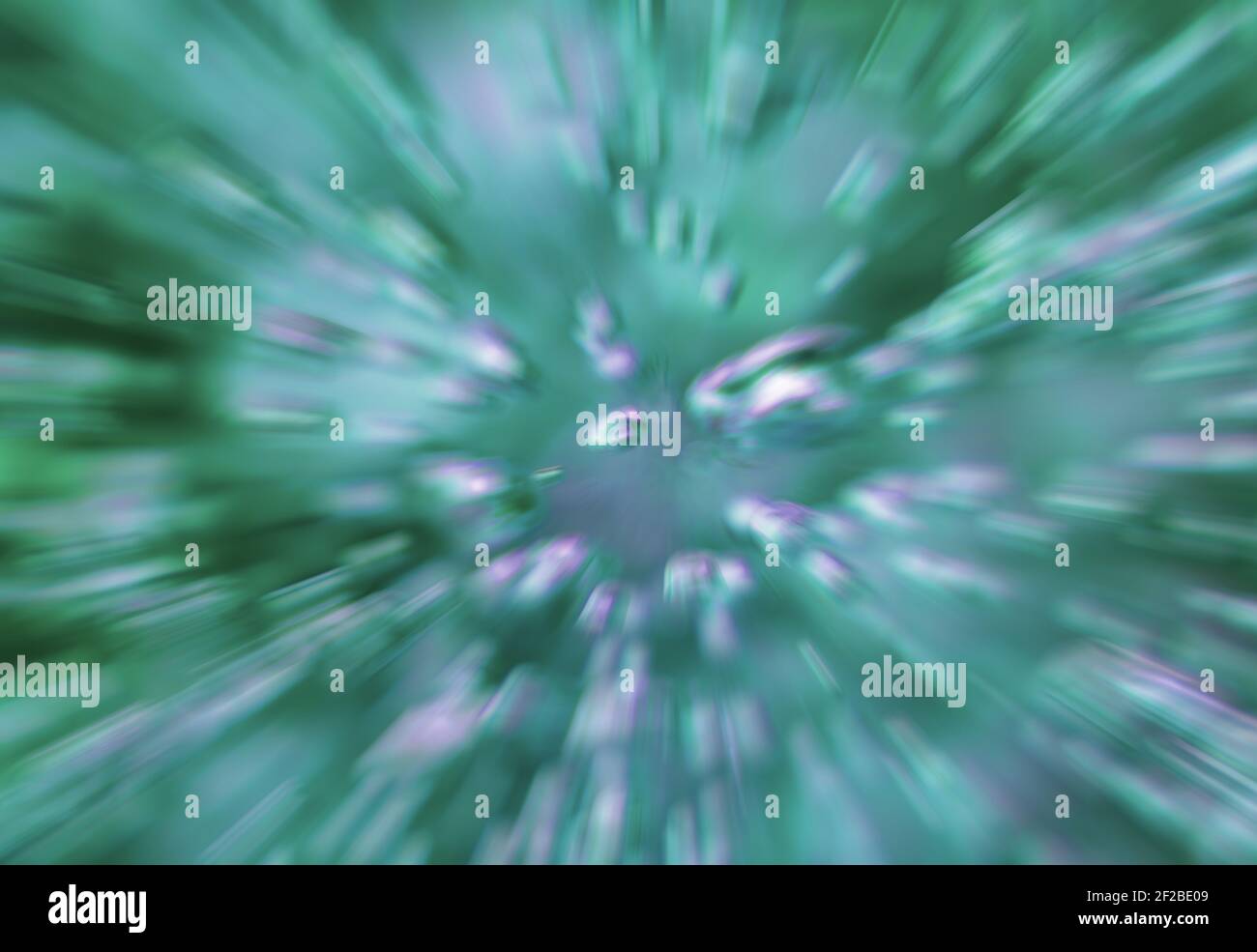 Green abstract background - radially acceleraed boiling water in a glass pot, Bubbles and splashes blurred. Stock Photo