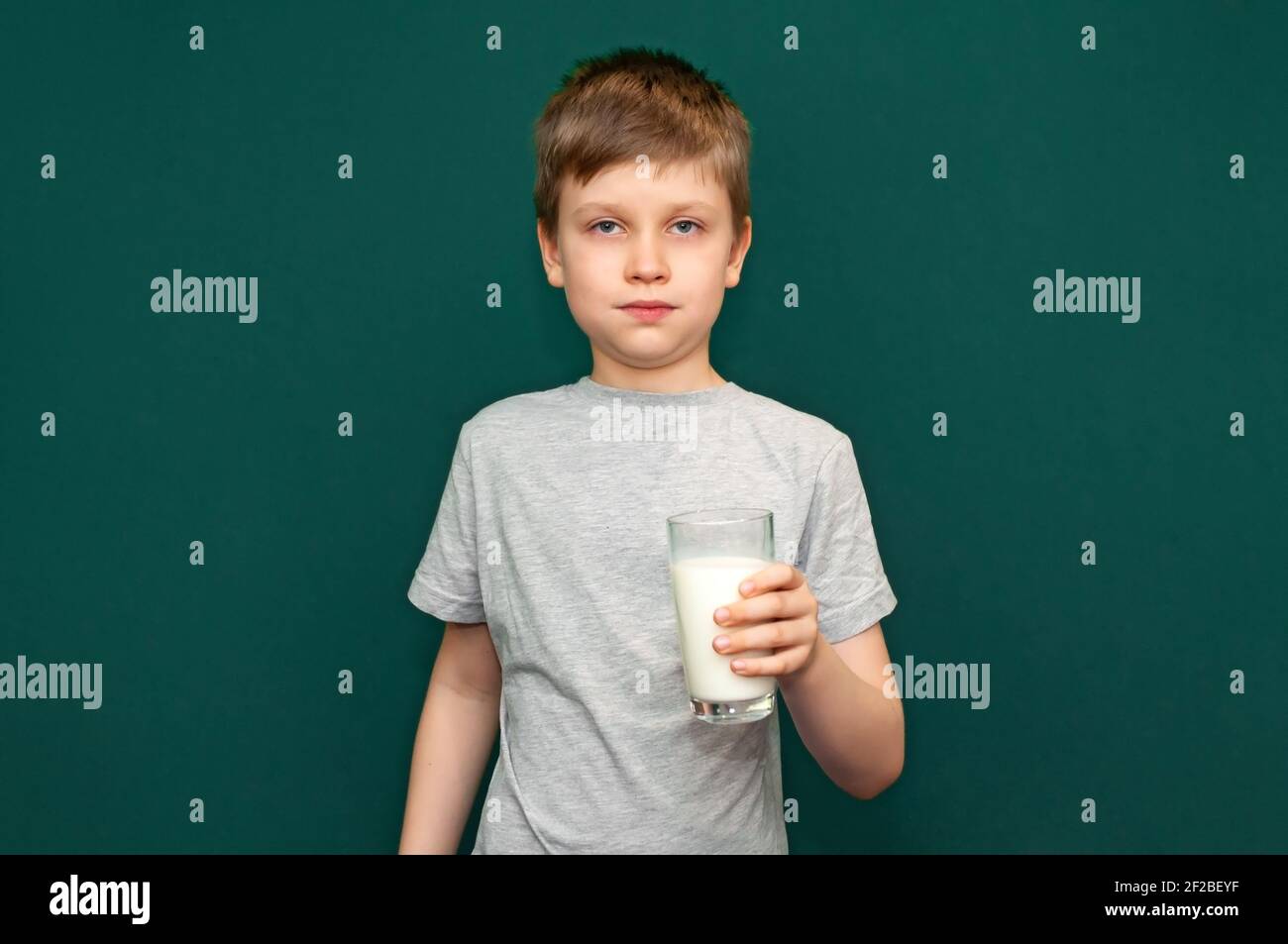 Boy child holding a glass of milk in her hands Stock Photo