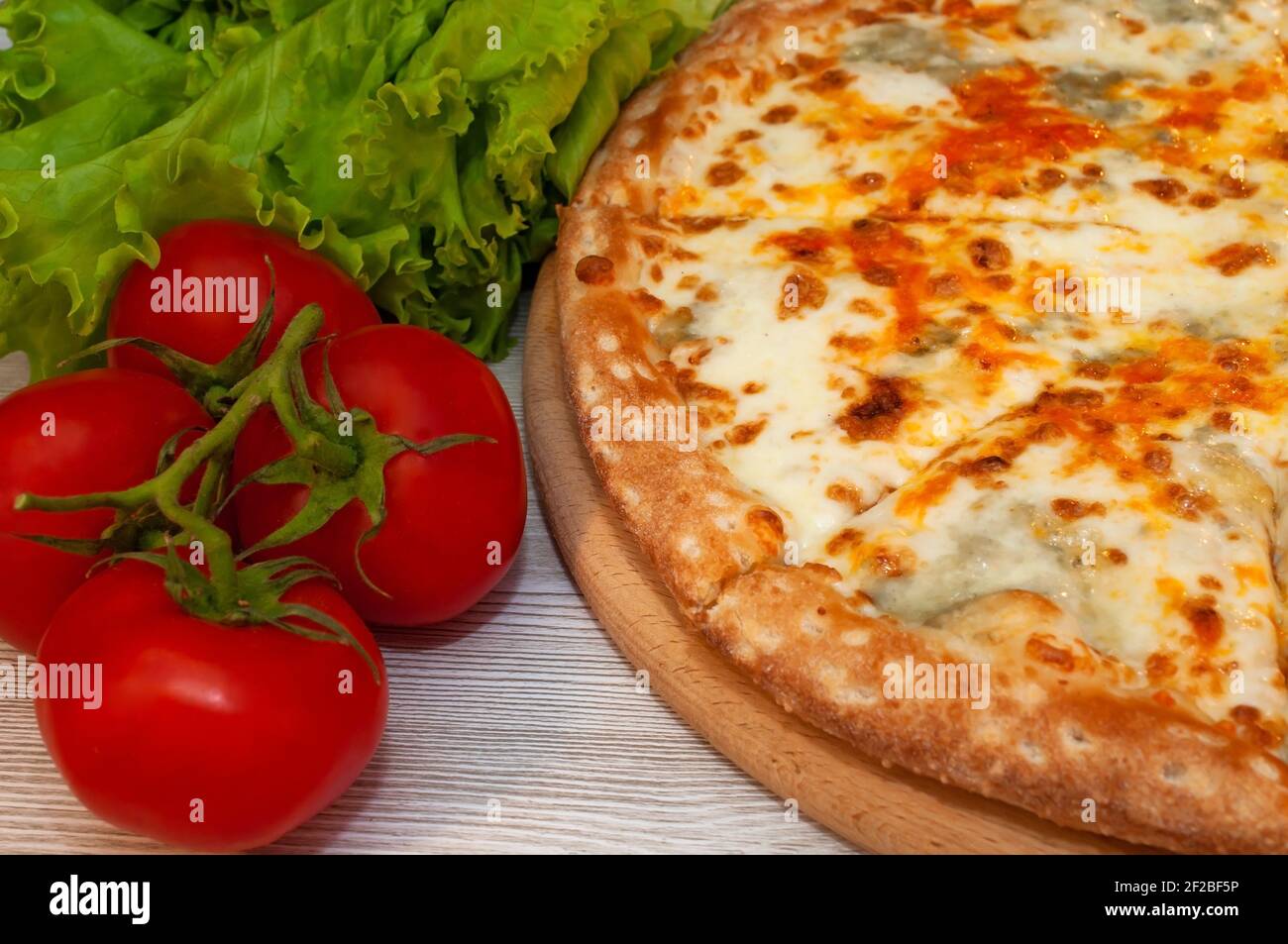 Four cheese pizza on a board. food Stock Photo