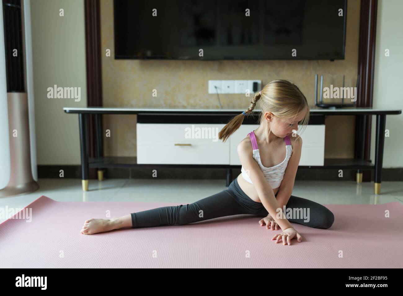 https://c8.alamy.com/comp/2F2BF95/cute-little-girl-in-sportswear-doing-fitness-exercises-at-home-distant-training-with-personal-trainer-social-distance-or-self-isolation-online-2F2BF95.jpg