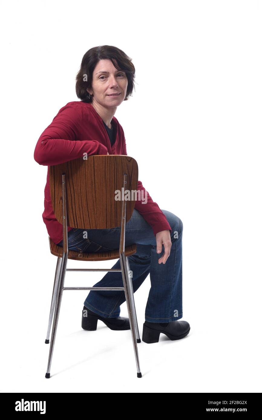 portrait of a woman sitting on a chair on white background Stock Photo ...