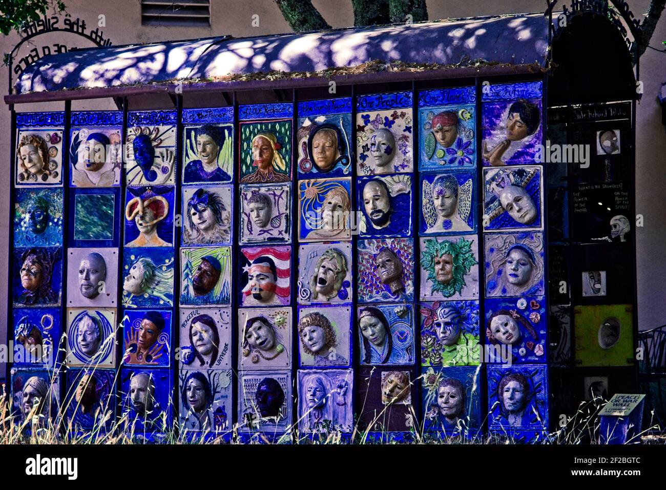 In the hills east of Santa Rosa, California, there is a grove of metal art sculptures called Marijke's Grove. This 'Peace Or War Wall' of faces Stock Photo