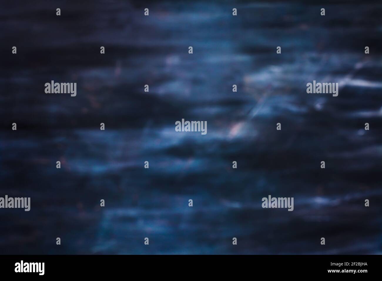 Unfocused dramatic blurred abstract of  an eerie dark, blue toned texture or background. Stock Photo