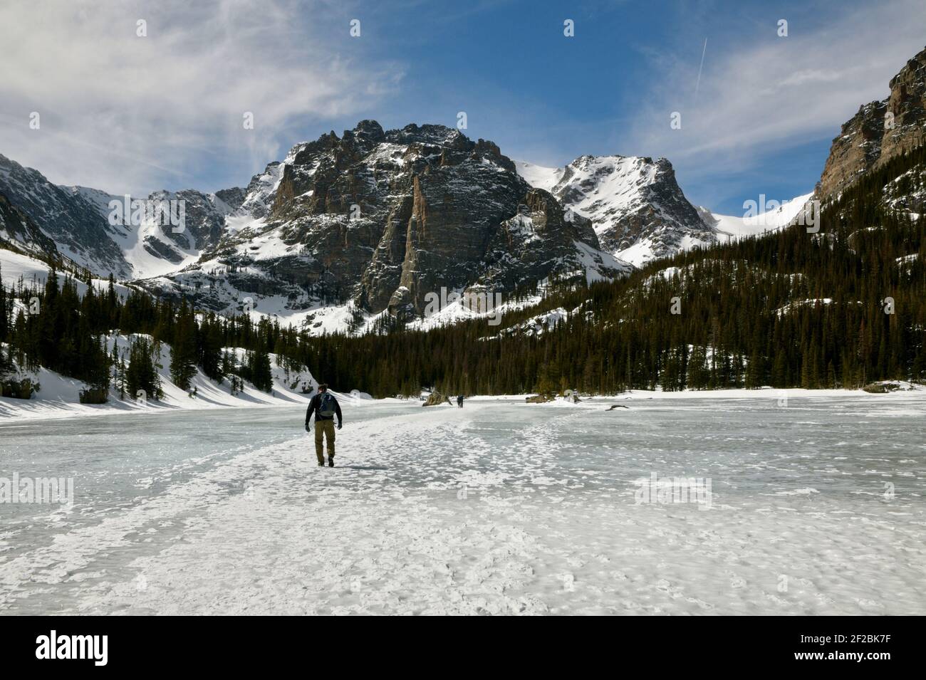 Sunny Winter Hiking through the Snow to the Loch and Lake of Glass with views of Sharkstooth and Taylor Peak in Rocky Mountain National Park, Colorado Stock Photo