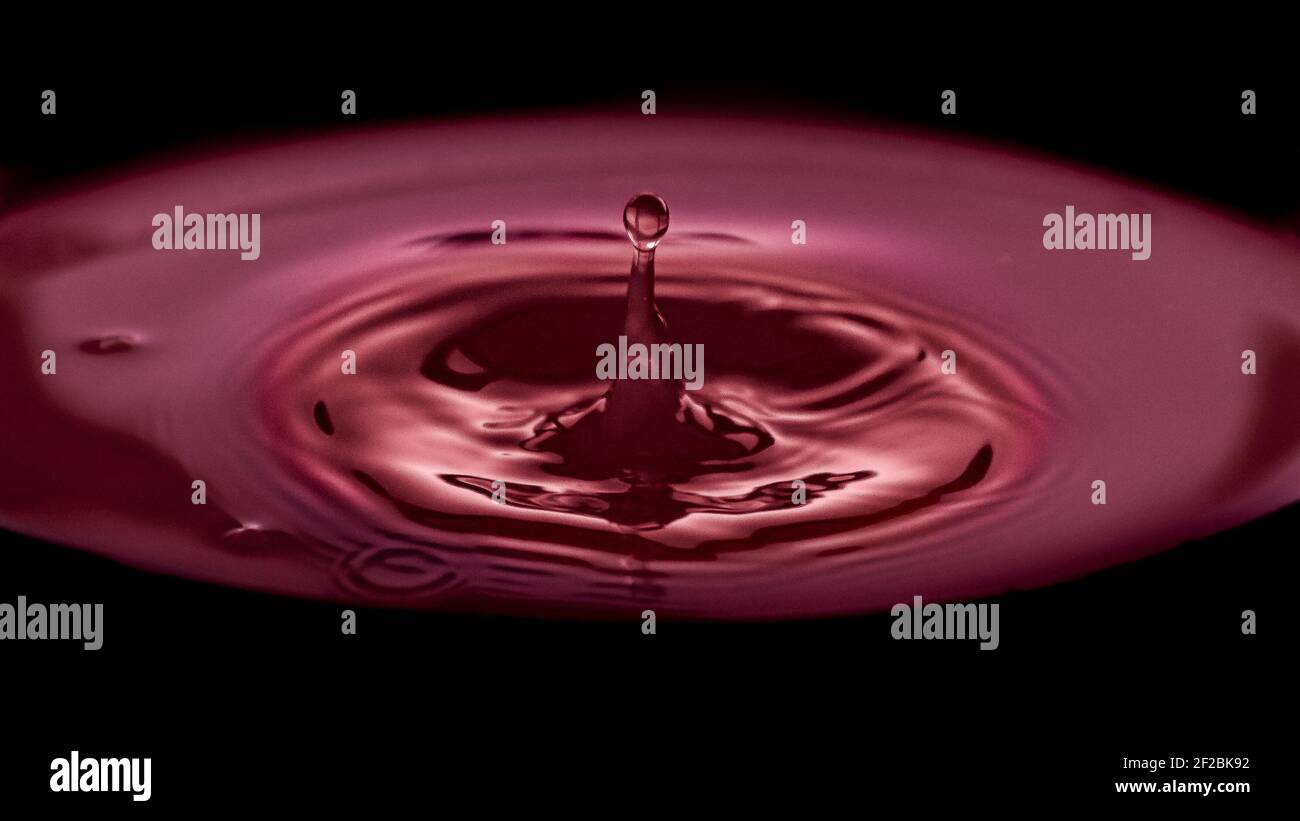 Drop Ripple Stock Image A water drop ripple on a red background Stock Photo - Alamy