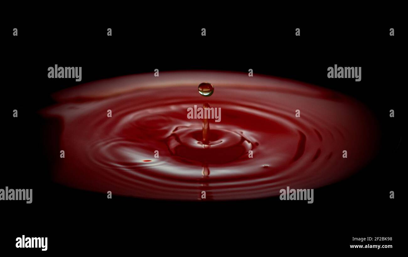 Drop Ripple Stock Image A water drop ripple on red background Stock Photo - Alamy