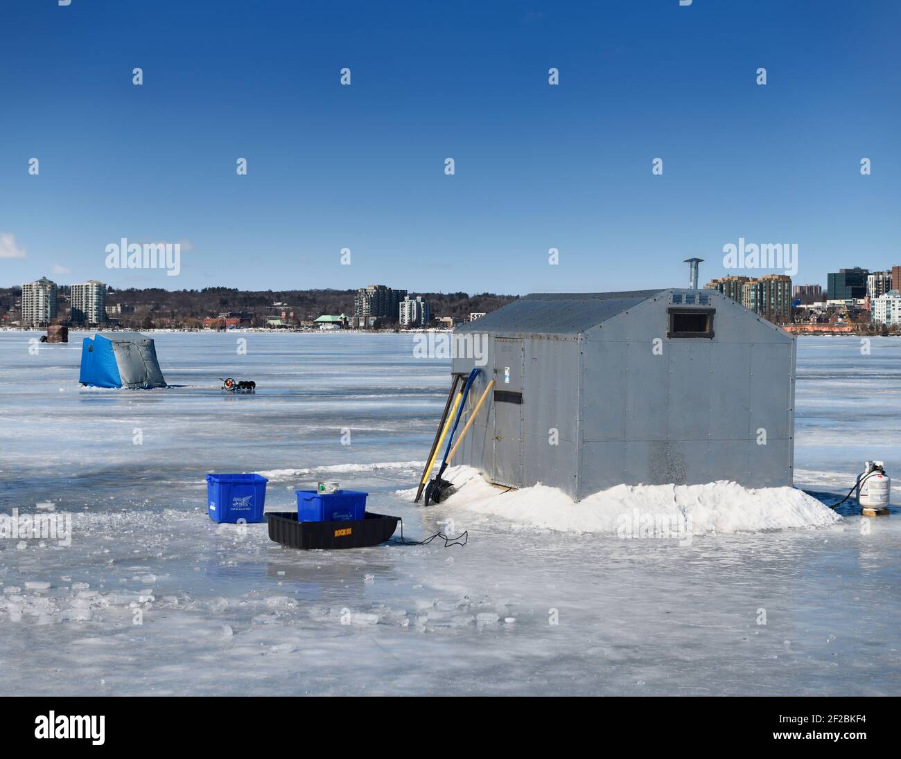 Ice fishing cabin and tents on frozen Kempenfelt Bay of Lake Simcoe at Barrie Canada in winter Stock Photo