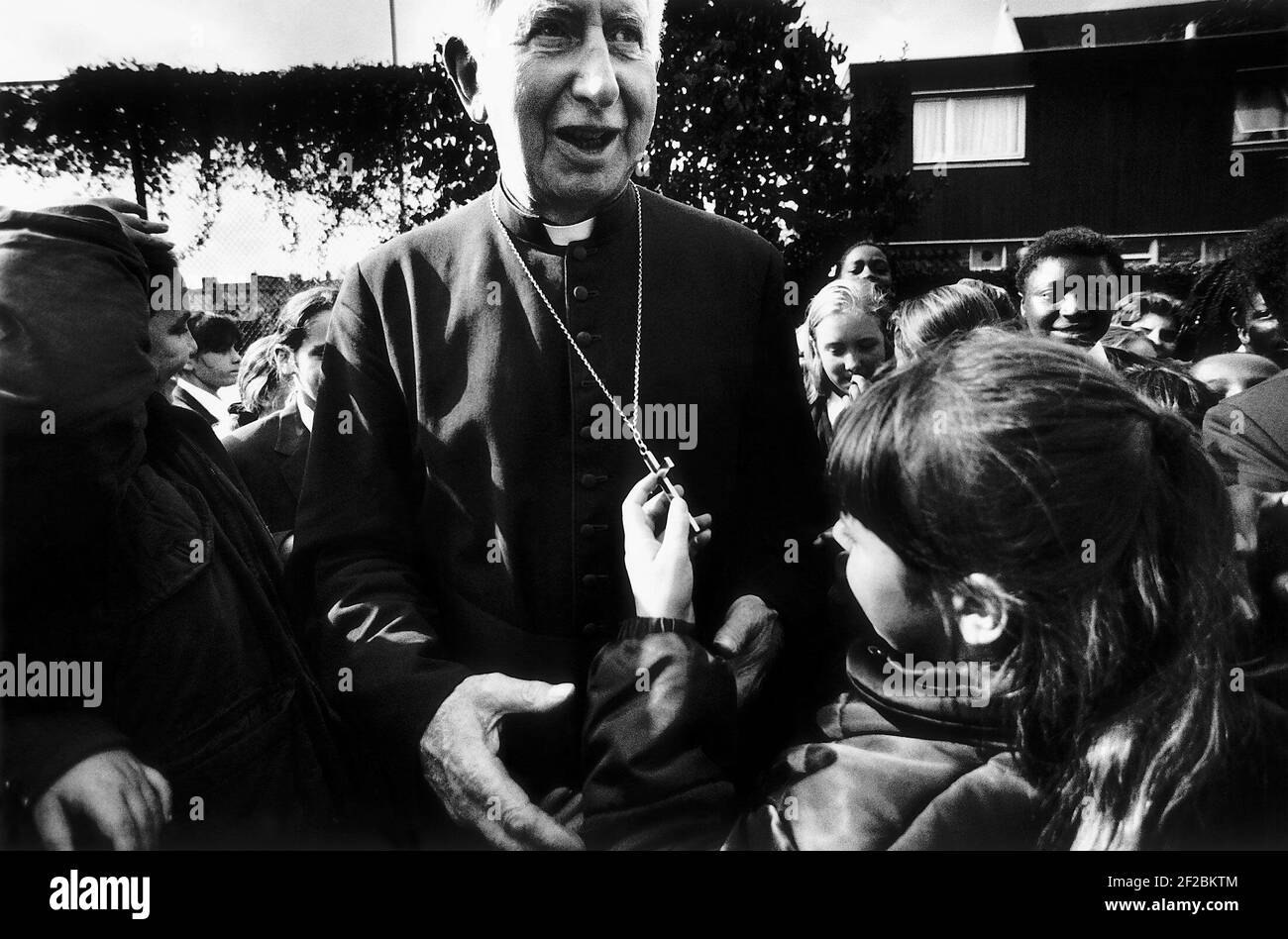 Cardinal Basil Hume  greeted by children before the opening of the new John Berchman wing at Bishop Challoner Roman Catholic school Stock Photo