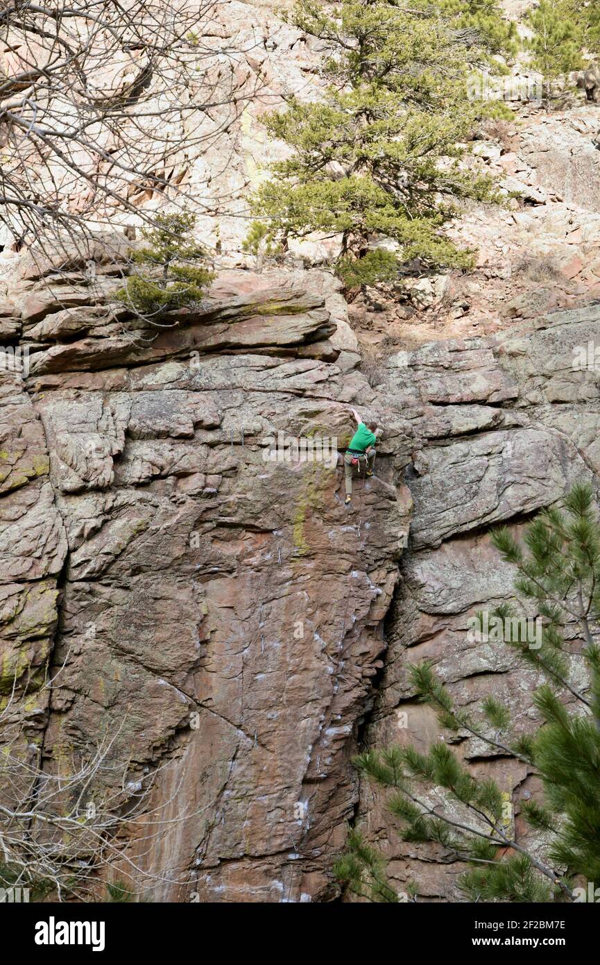 Rock Climber Climbing Granite Wall at Button Rock Reservoir above the North Saint Vrain Creek in Lyons, Colorado United States Stock Photo