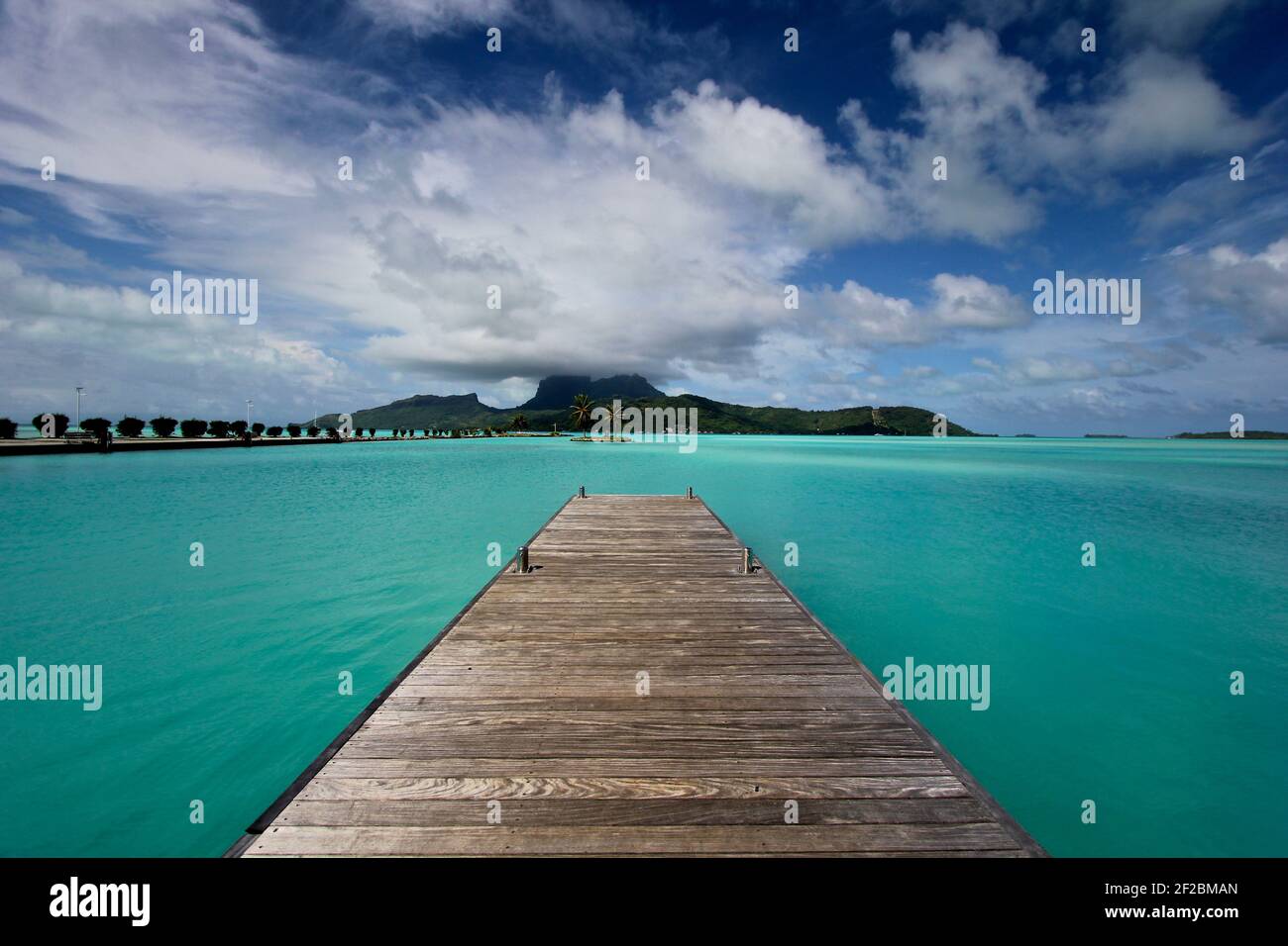 Dock in clear turquoise water on Bora Bora, French Polynesia Stock Photo