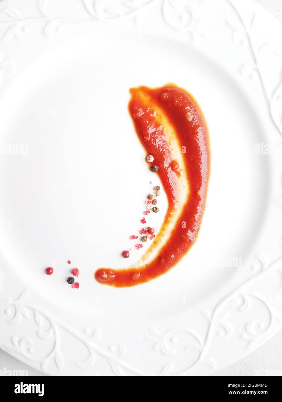 Ketchup in a sauce bowl on a white background Stock Photo