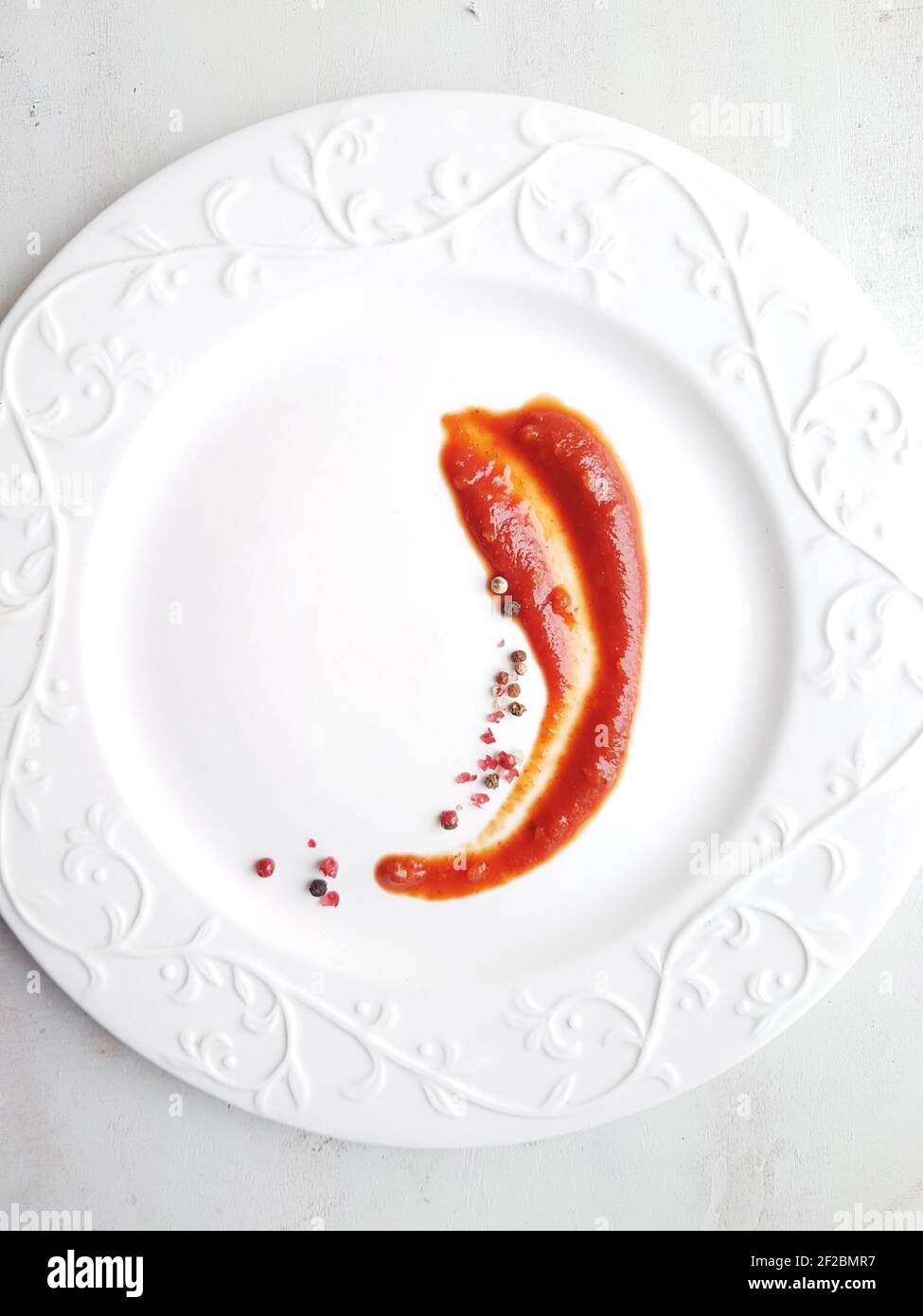 Ketchup in a sauce bowl on a white background Stock Photo