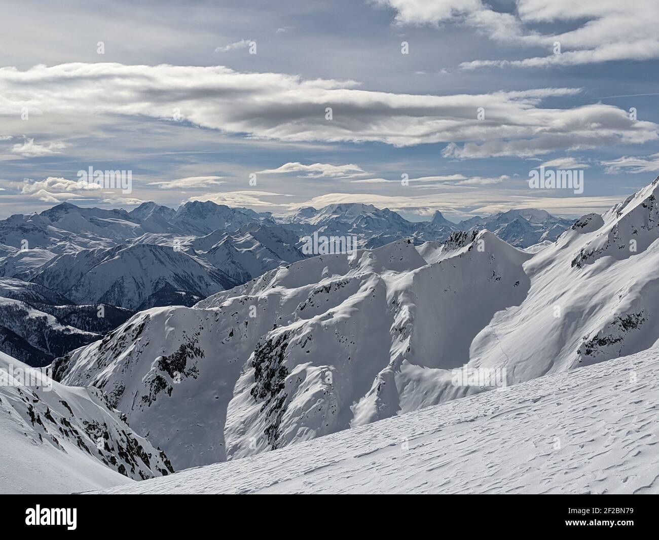 skimo, ski mountaineering above goms in the canton of valais with a view of the matterhon. Cloudy day in the mountains Stock Photo