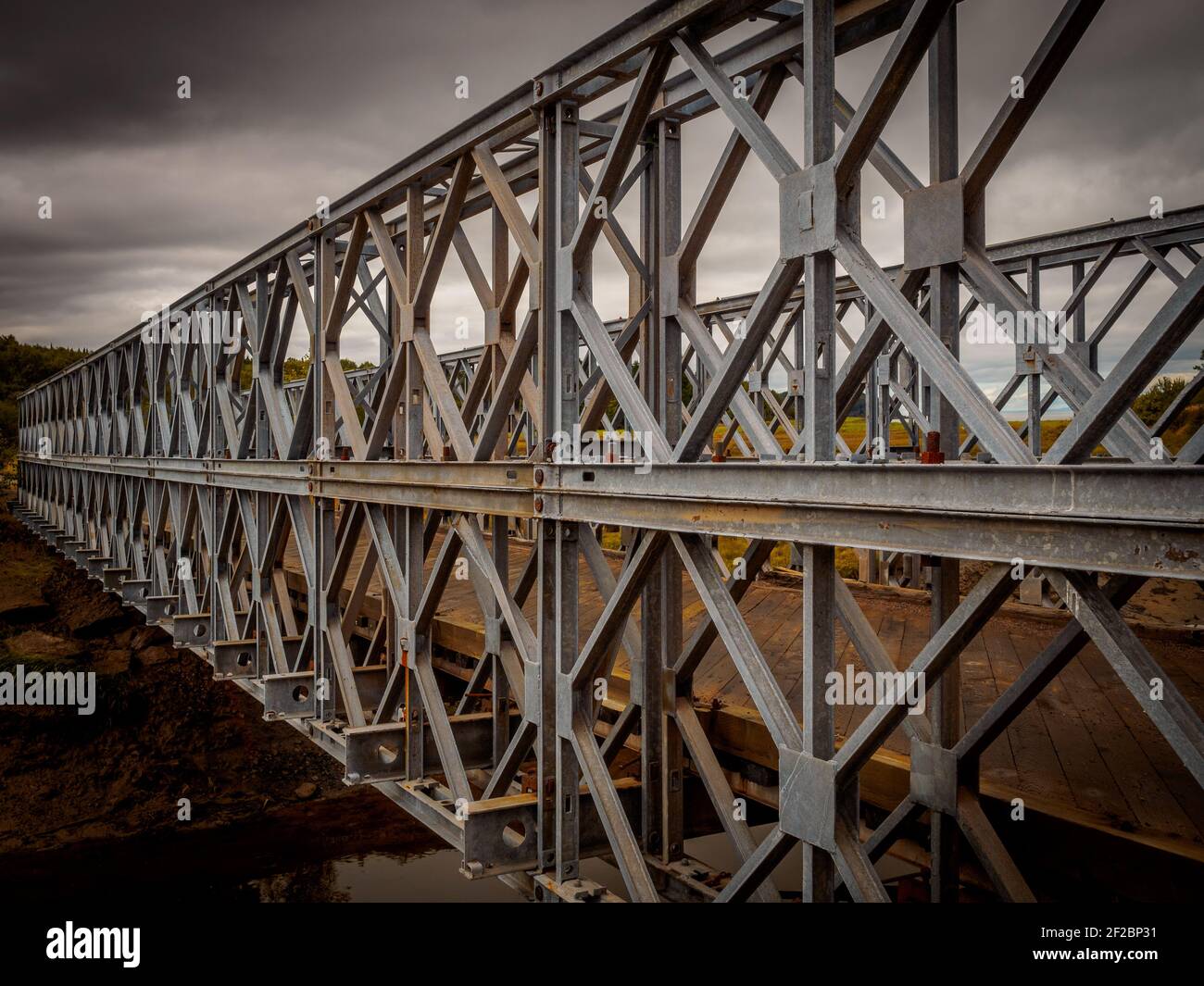 Splendid and typical iron girder bridge with a wooden platform near