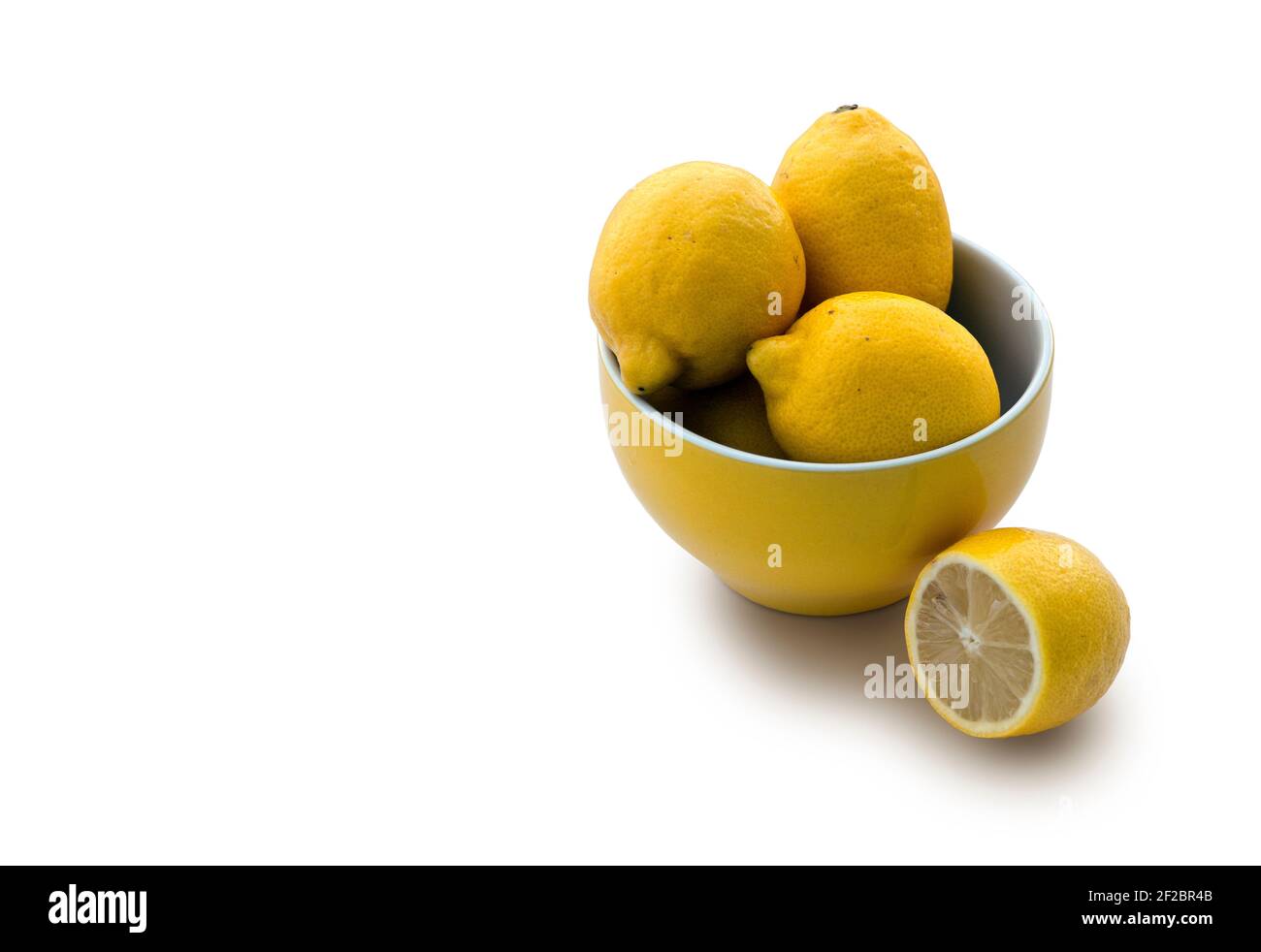 Yellow bowl full with lemons with copy space Stock Photo Alamy