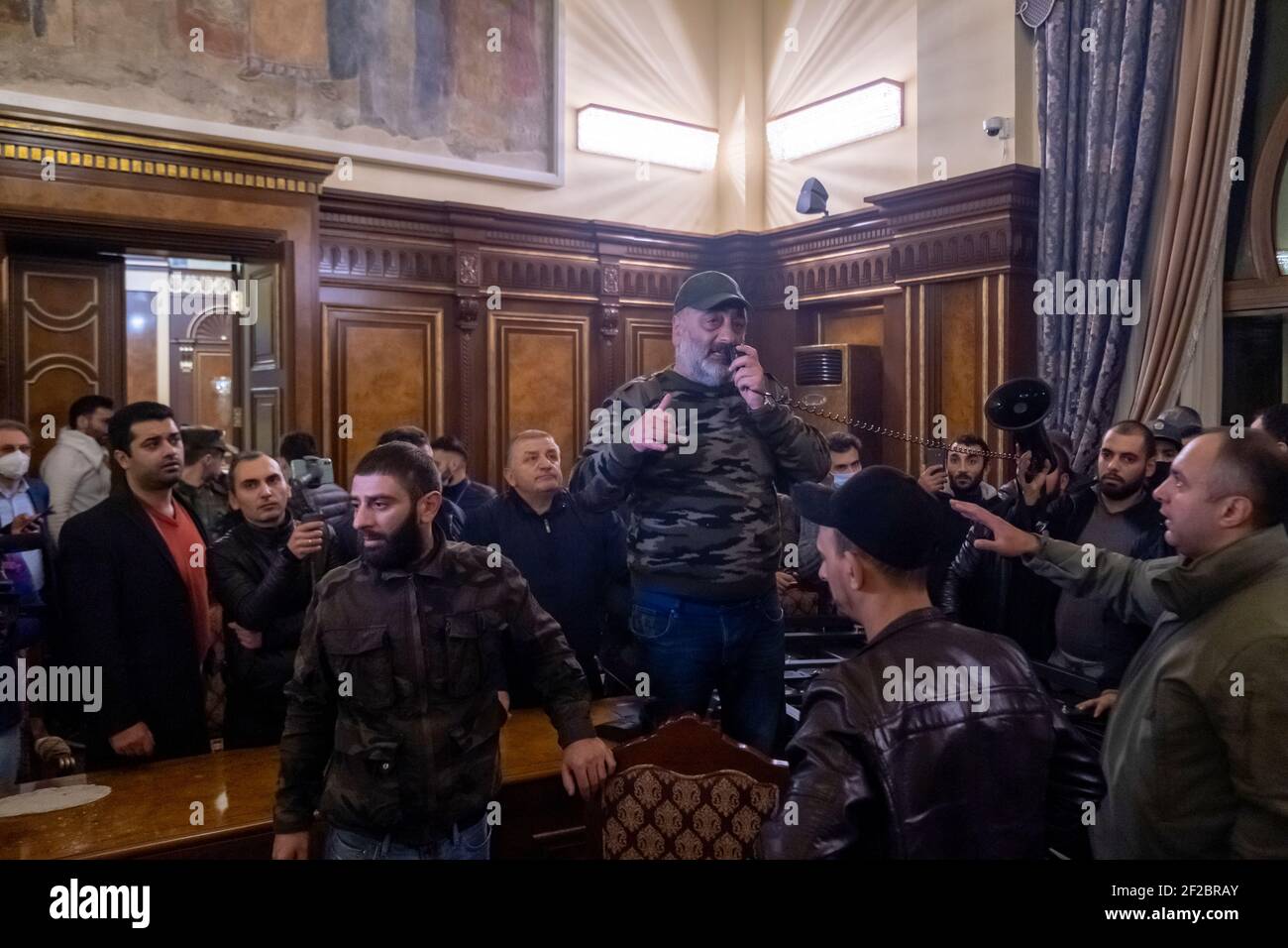 YEREVAN, ARMENIA - NOVEMBER 10: Armenians storm into the building housing the official residence of the Armenian prime minister soon after a peace deal was signed between their country, Azerbaijan and Russia on November 10 2020 in central Yerevan. Armenia's prime minister Pashinyan, Russia's president Putin and Azerbaijan's president Aliyev signed an agreement to end the war in Nagorno Karabakh known also as the Artsakh Republic which re-erupted in late September into a six-week war that left thousands dead. Stock Photo
