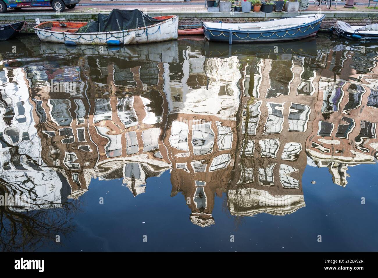 Buildings and boats reflected in Egelantiersgracht, Amsterdam, Netherlands. Stock Photo