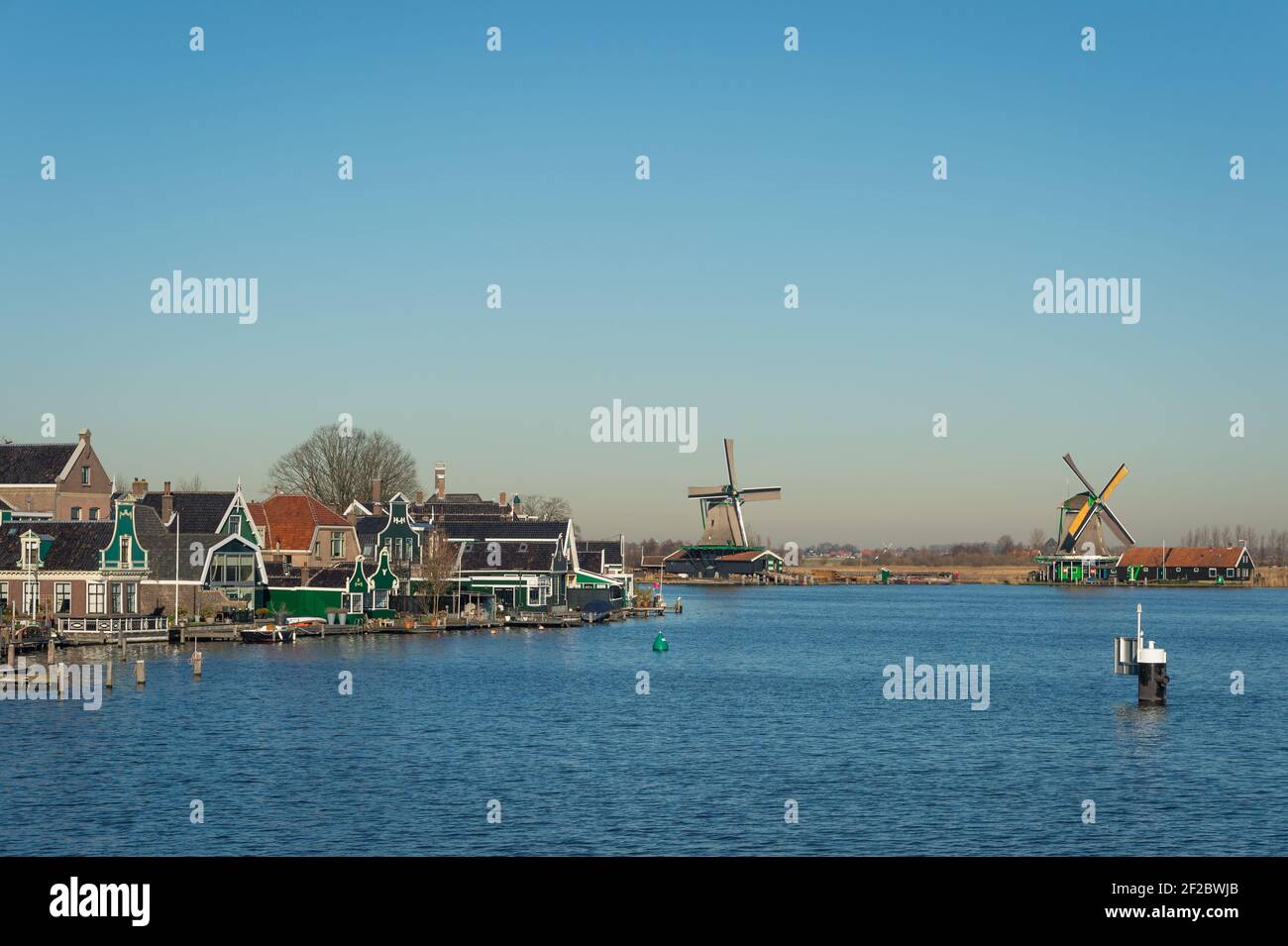 Historic windmills in Zaanse Schans on the banks of the Zaan river, Zaandijk, Netherlands. Stock Photo