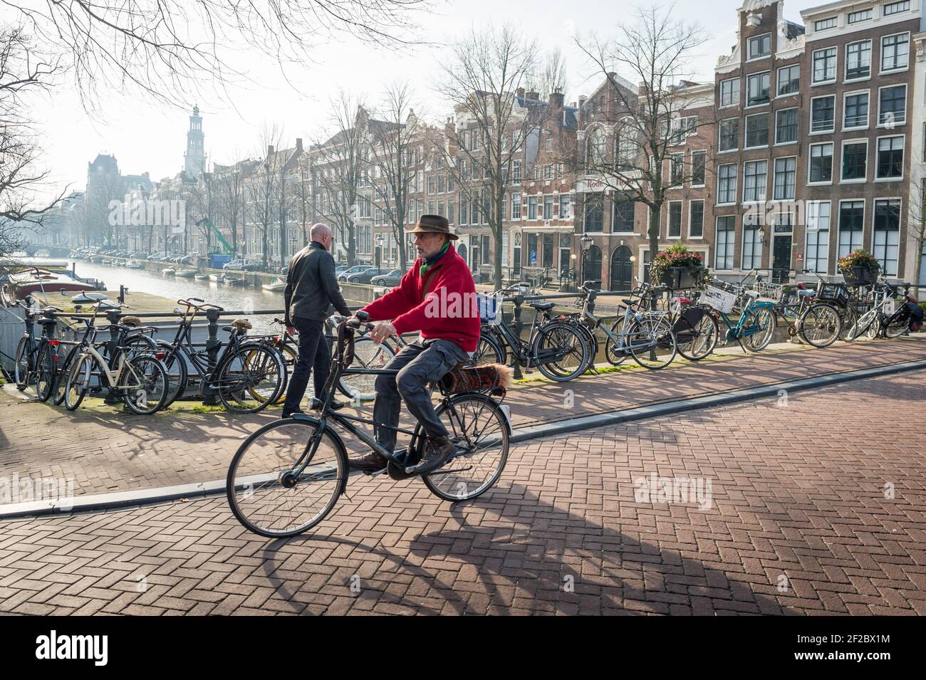 Cyclist canal amsterdam netherlands hi-res stock photography and 