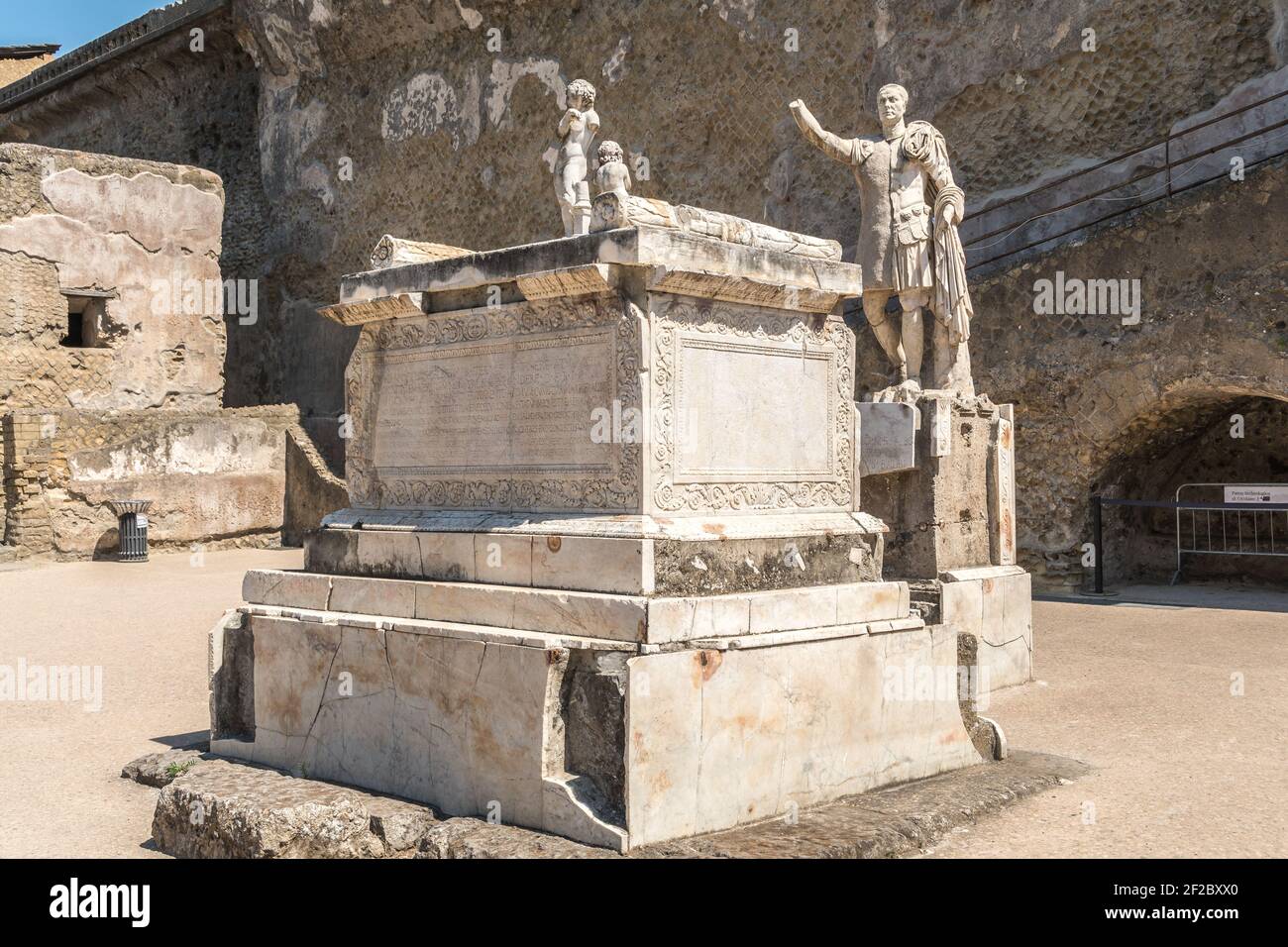Marble statues among Herculaneum's ruins, marble altar and statue of the donator of the basilica