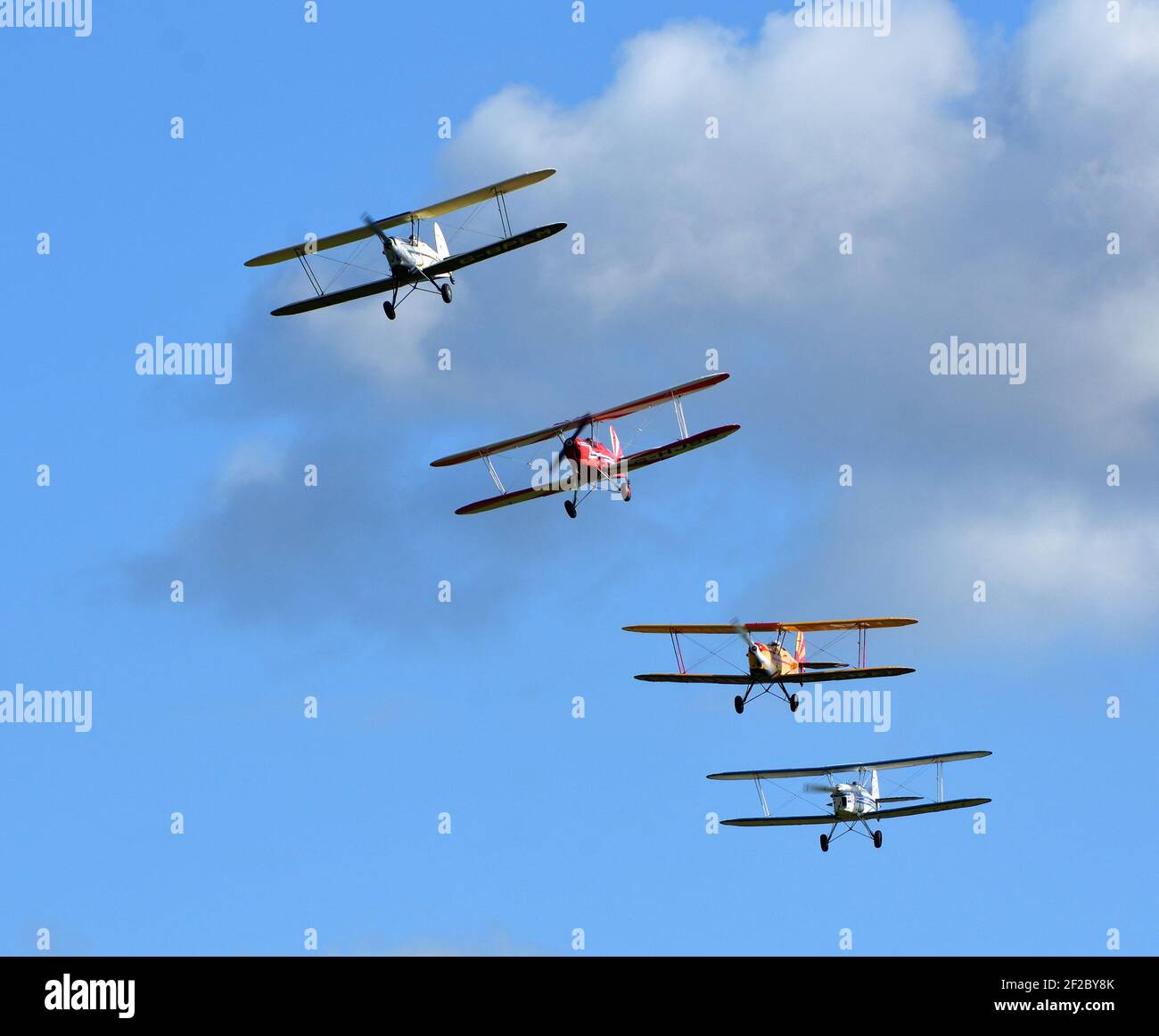 Four Vintage  SNCAN Stampe - Vertongen SV-4 Biplanes in flying formation. Stock Photo