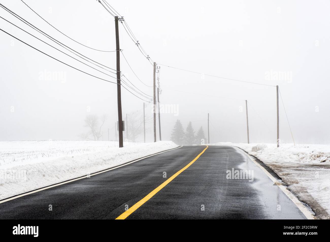 A road in rural Templeton, Massachusetts on a foggy winter's day Stock Photo