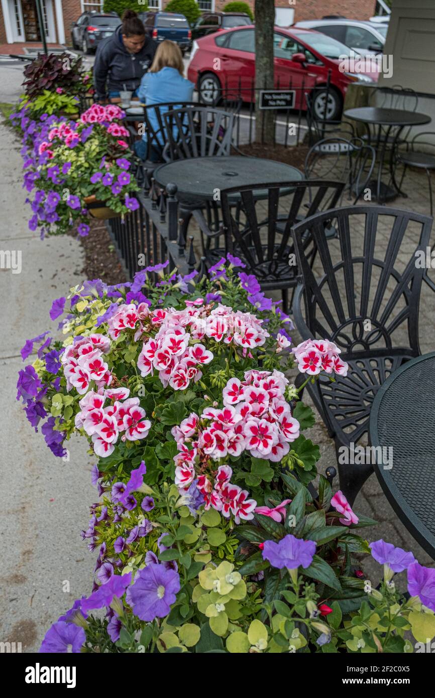 Flowers and dining tables outside a restaurant in Peterborough, New Hampshire Stock Photo