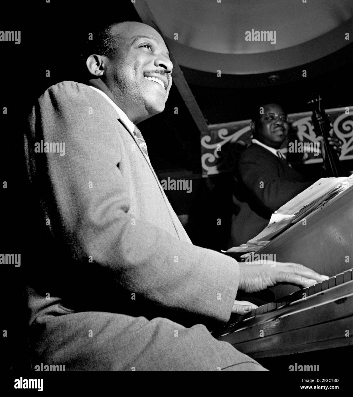 Count Basie. Portrait of the American jazz pianist, Count Basie (William James Basie, 1904-1984) playing the piano at the Aquarium, New York City, between 1946 and 1948. Stock Photo