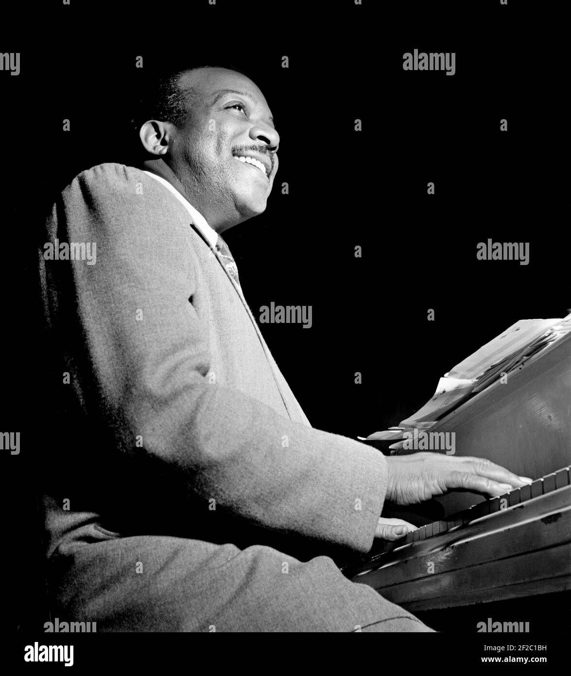 Count Basie. Portrait of the American jazz pianist, Count Basie (William James Basie, 1904-1984) playing the piano at the Aquarium, New York City, between 1946 and 1948. Stock Photo