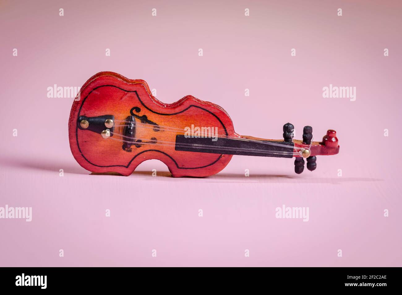 A miniature violin for a dollhouse Stock Photo