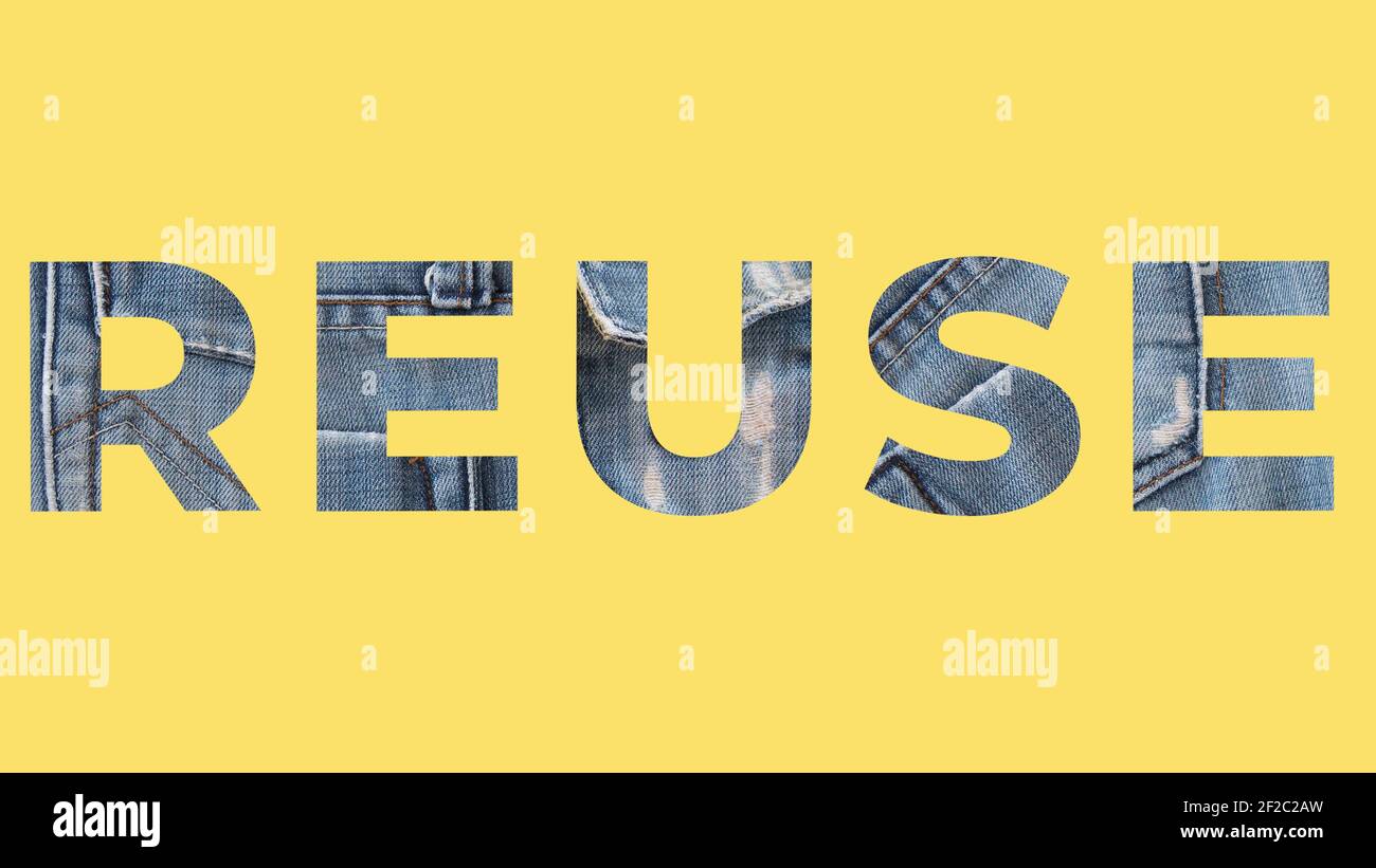 Reuse word from denim on yellow background. Recycle jeans concept Stock Photo